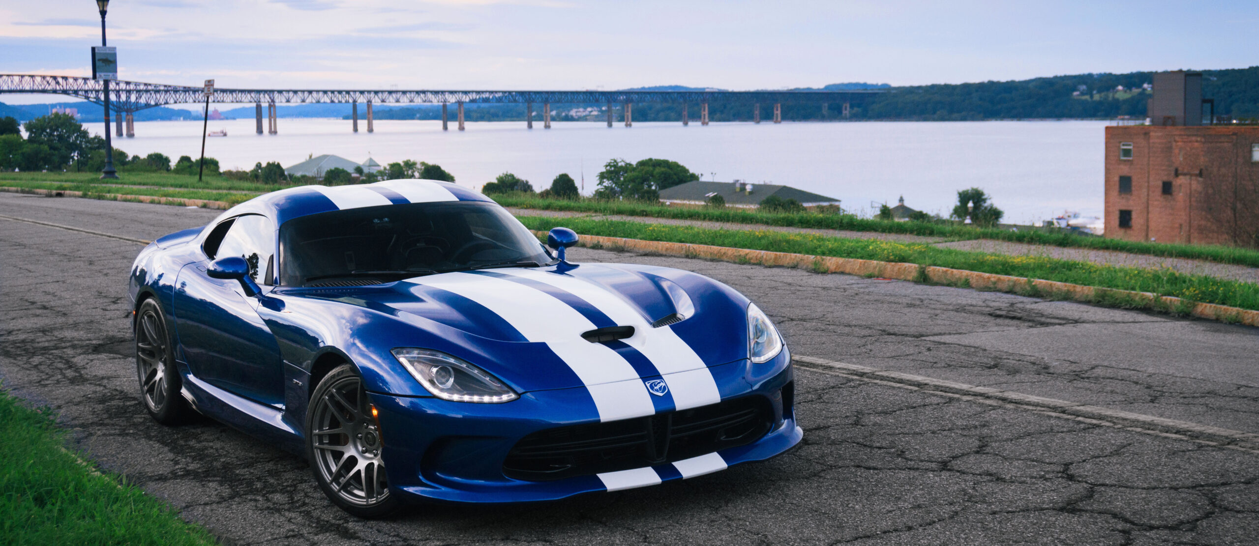 The founder’s blue Viper GTS beside the Hudson River