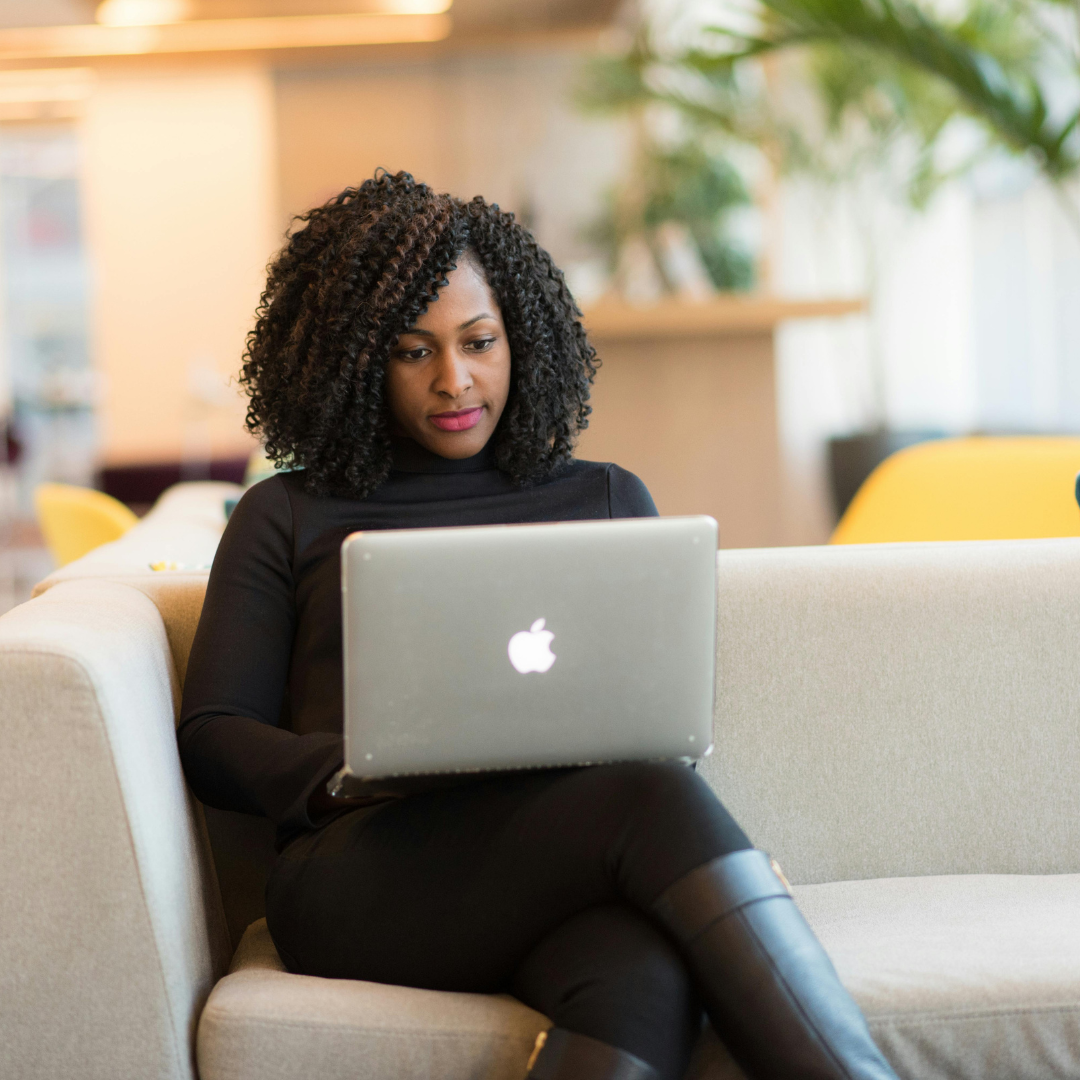 A woman holding her laptop